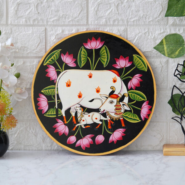 This beautiful pichwai painting features the Hindu deity Krishna cradling his beloved calf, surrounded by a vibrant array of flowers.